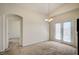Light-filled dining area with french doors, modern chandelier, and a doorway leading to other spaces at 8768 Tom Noon Ave # 101, Las Vegas, NV 89178