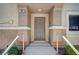 Welcoming front entrance featuring a contemporary door, railing, and manicured shrubbery at 8768 Tom Noon Ave # 101, Las Vegas, NV 89178
