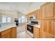 Open concept kitchen with wooden cabinets, white countertops and stainless steel appliances at 8768 Tom Noon Ave # 101, Las Vegas, NV 89178