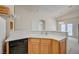 View of the kitchen with wooden cabinets, white countertops and a black dishwasher at 8768 Tom Noon Ave # 101, Las Vegas, NV 89178