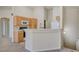View of the kitchen featuring wooden cabinets, a breakfast bar and white appliances at 8768 Tom Noon Ave # 101, Las Vegas, NV 89178