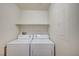 Laundry room with a washer, dryer, and shelf space to provide an organized space at 8768 Tom Noon Ave # 101, Las Vegas, NV 89178