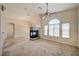 Bright living room featuring a fireplace, ceiling fan and lots of natural light from the many windows at 8768 Tom Noon Ave # 101, Las Vegas, NV 89178
