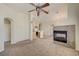 Spacious living area with a modern fireplace, seamlessly connecting the kitchen and dining spaces at 8768 Tom Noon Ave # 101, Las Vegas, NV 89178