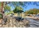 Park scene featuring picnic tables, shade structures, and walking paths under mature trees at 8768 Tom Noon Ave # 101, Las Vegas, NV 89178