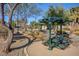 Community picnic area with covered seating, landscaping, and walking paths in a well-maintained common area at 8768 Tom Noon Ave # 101, Las Vegas, NV 89178