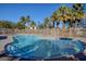 Refreshing community pool surrounded by lush palm trees, offering a relaxing oasis at 8768 Tom Noon Ave # 101, Las Vegas, NV 89178