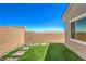 Low-maintenance backyard featuring artificial turf and minimalist landscaping with mountain views at 879 Klamath Springs St, Henderson, NV 89011