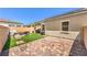 Inviting backyard patio with artificial turf, seating area, and brick pavers perfect for entertaining at 879 Klamath Springs St, Henderson, NV 89011