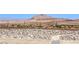 Landscaped backyard features a serene view of the desert and a distant mountain range at 879 Klamath Springs St, Henderson, NV 89011