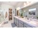 Bright bathroom features double sinks, a large mirror, and a walk-in closet for ample storage at 879 Klamath Springs St, Henderson, NV 89011