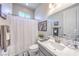 Simple bathroom with a framed mirror, shower curtain, and white marble countertops at 879 Klamath Springs St, Henderson, NV 89011