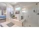 Modern bathroom showcasing a soaking tub and a glass-enclosed shower with white tile and fixtures at 879 Klamath Springs St, Henderson, NV 89011