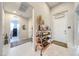 Inviting entryway with white tiled floor and decorative shelving, leading to the kitchen and front door at 879 Klamath Springs St, Henderson, NV 89011