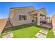 Home exterior showcasing a covered patio, artificial turf and neutral color palette at 879 Klamath Springs St, Henderson, NV 89011