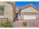 Inviting front entrance showcasing a well-maintained lawn, stone accents, and a two-car garage at 879 Klamath Springs St, Henderson, NV 89011
