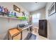 Functional laundry room with modern washer and dryer, storage shelves, and practical design at 879 Klamath Springs St, Henderson, NV 89011