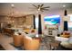 Open-concept living room with stylish furniture, a modern ceiling fan, and lots of light at 879 Klamath Springs St, Henderson, NV 89011