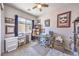 Comfortable home office with a large window, stylish desk, neutral carpet, and modern ceiling fan at 879 Klamath Springs St, Henderson, NV 89011
