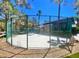 Enclosed basketball court surrounded by trees and protective fencing, offering a private and secure recreational area at 9050 Warm Springs Rd # 2050, Las Vegas, NV 89148