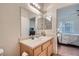 Light and airy bathroom with a large mirror and updated vanity at 9050 Warm Springs Rd # 2050, Las Vegas, NV 89148