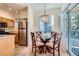 The breakfast nook features stylish chandelier and sliding glass doors leading to the outdoor balcony at 9050 Warm Springs Rd # 2050, Las Vegas, NV 89148