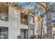 A condo building with balconies, complemented by mature trees, providing a serene outdoor space at 9050 Warm Springs Rd # 2050, Las Vegas, NV 89148