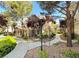 Beautifully landscaped condominium exterior with walking paths and lush greenery on a sunny day at 9050 Warm Springs Rd # 2050, Las Vegas, NV 89148