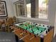 Well-equipped game room featuring a foosball table and comfortable seating with a pool view at 9050 Warm Springs Rd # 2050, Las Vegas, NV 89148