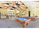 Spacious game room with pool tables, comfortable seating, and ample natural light for entertainment at 9050 Warm Springs Rd # 2050, Las Vegas, NV 89148