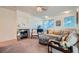 Cozy living room featuring a decorative fireplace, neutral color palette, and comfortable furnishings at 9050 Warm Springs Rd # 2050, Las Vegas, NV 89148
