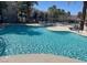 Large community pool featuring crystal-clear water and comfortable lounge chairs for relaxing poolside at 9050 Warm Springs Rd # 2050, Las Vegas, NV 89148