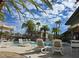 Inviting pool area with lounge chairs, umbrellas, and palm trees for a resort-style living experience at 9050 Warm Springs Rd # 2050, Las Vegas, NV 89148