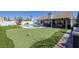 This backyard features a pool, putting green, and covered patio, perfect for outdoor entertaining at 9100 Shelter Cove Ct, Las Vegas, NV 89117