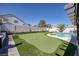 Lush backyard featuring a putting green and a sparkling swimming pool, ideal for outdoor fun at 9100 Shelter Cove Ct, Las Vegas, NV 89117