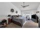 Cozy bedroom with ceiling fan and natural light streaming through the windows at 9100 Shelter Cove Ct, Las Vegas, NV 89117