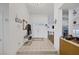 Bright foyer with white walls, tiled flooring, and clear sight lines into the kitchen and living area at 9100 Shelter Cove Ct, Las Vegas, NV 89117