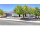 Single-story house with desert landscaping, two-car garage, and a covered front porch at 9100 Shelter Cove Ct, Las Vegas, NV 89117