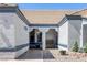 Inviting front porch with a hanging swing, textured stucco walls, and tile roof, offering a cozy outdoor space at 9100 Shelter Cove Ct, Las Vegas, NV 89117