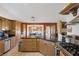 Spacious kitchen boasts granite counters, stainless appliances, and an open dining area at 9100 Shelter Cove Ct, Las Vegas, NV 89117