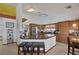 Kitchen with granite countertops, breakfast bar, stainless steel appliances, and wood cabinets at 9100 Shelter Cove Ct, Las Vegas, NV 89117