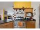 Kitchen with stainless steel stove, granite countertops, and wood cabinetry at 9100 Shelter Cove Ct, Las Vegas, NV 89117