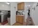Hallway with storage cabinets leading to laundry machines at 9100 Shelter Cove Ct, Las Vegas, NV 89117
