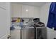 Well-equipped laundry room featuring modern washer and dryer units at 9100 Shelter Cove Ct, Las Vegas, NV 89117