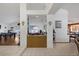 Open-concept living area featuring a wet bar, tiled floors, and views into other living spaces at 9100 Shelter Cove Ct, Las Vegas, NV 89117