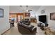 Spacious living room featuring a leather sectional, tile flooring, and cozy fireplace at 9100 Shelter Cove Ct, Las Vegas, NV 89117