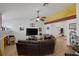 Comfortable living room with tile floors, sectional sofa, and a large entertainment center at 9100 Shelter Cove Ct, Las Vegas, NV 89117