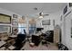 This office features multiple desks, sports memorabilia, and a ceiling fan, offering a functional workspace at 9100 Shelter Cove Ct, Las Vegas, NV 89117