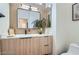 Modern bathroom featuring a wood vanity, large mirror, and stylish fixtures at 916 Pro Players Dr, Las Vegas, NV 89134