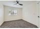 Neutral bedroom featuring shuttered windows, ceiling fan and neutral carpeting at 916 Pro Players Dr, Las Vegas, NV 89134